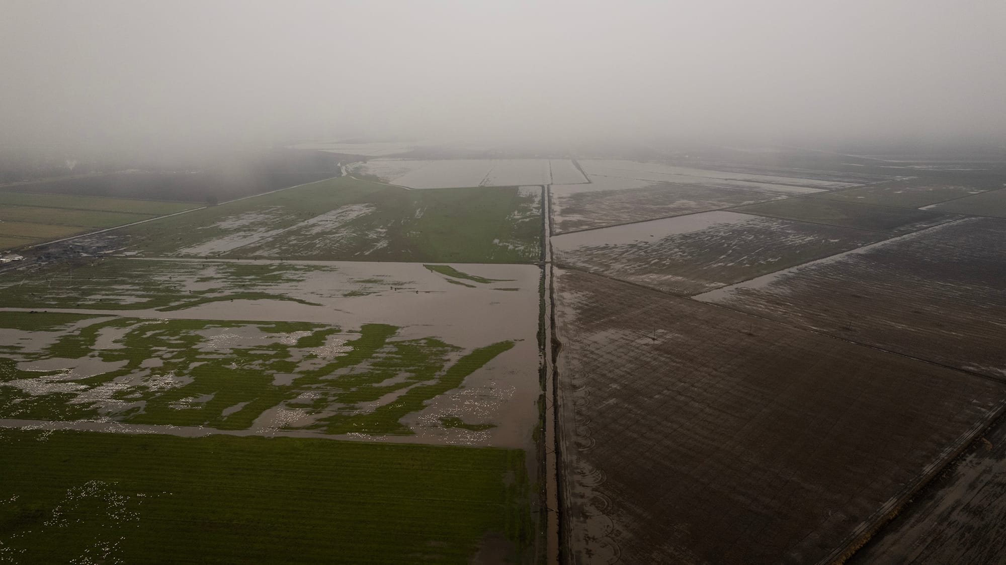 An aerial view of flooded fields off of River Road near Locke on Jan. 3, 2022. Northern California was hit by a major rainstorm that caused power outages, landslides and flooding over the New Year's holiday weekend. Photo by Miguel Gutierrez Jr., CalMatters